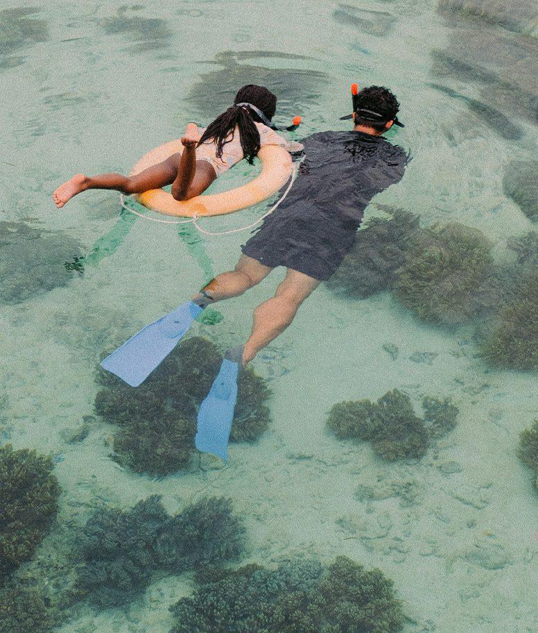 father and daughter snorkeling