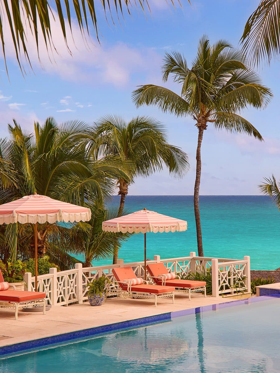 pool deck with loungers and the ocean beyond